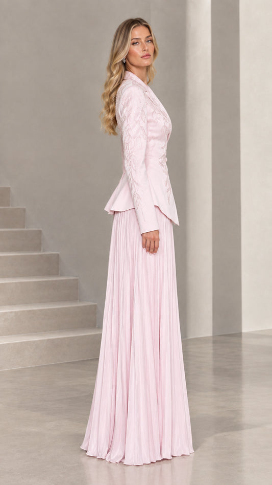 Side profile view of blush pink peplum jacket and accordion pleated formal skirt