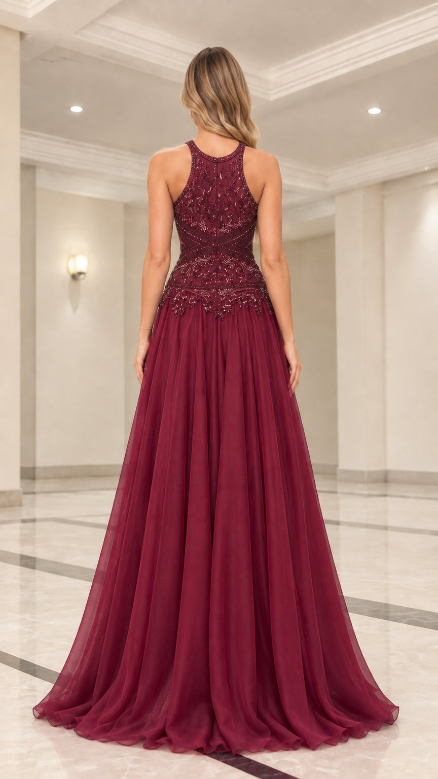 Back view of model in burgundy halter neck evening gown with flowy skirt