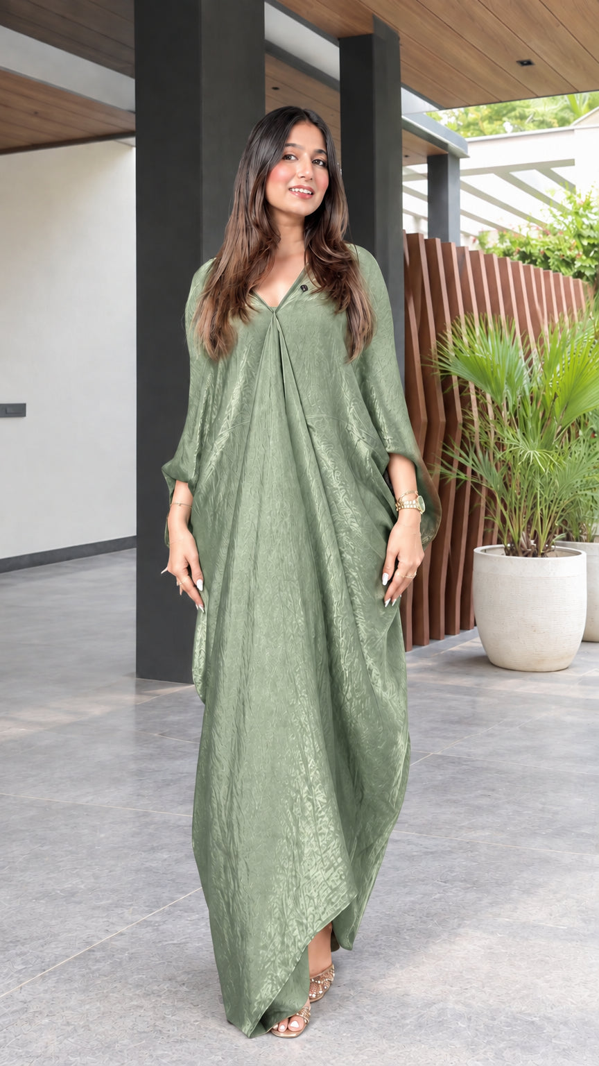 Front view of model wearing a sage green textured V-neck maxi kaftan dress
