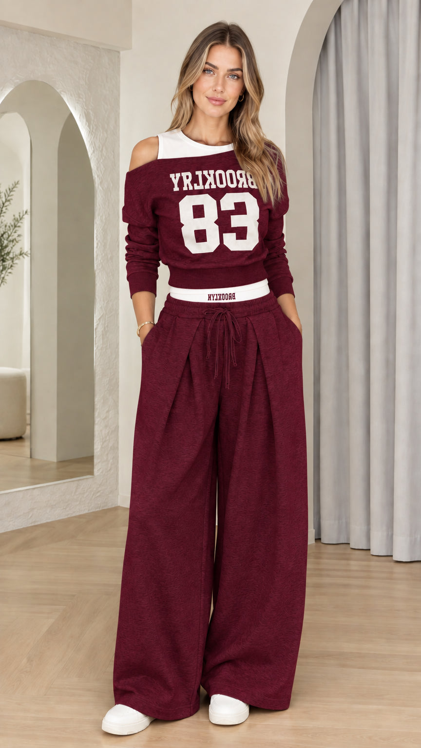 Front view of woman wearing Burgundy Brooklyn 83 graphic two-piece wide-leg set