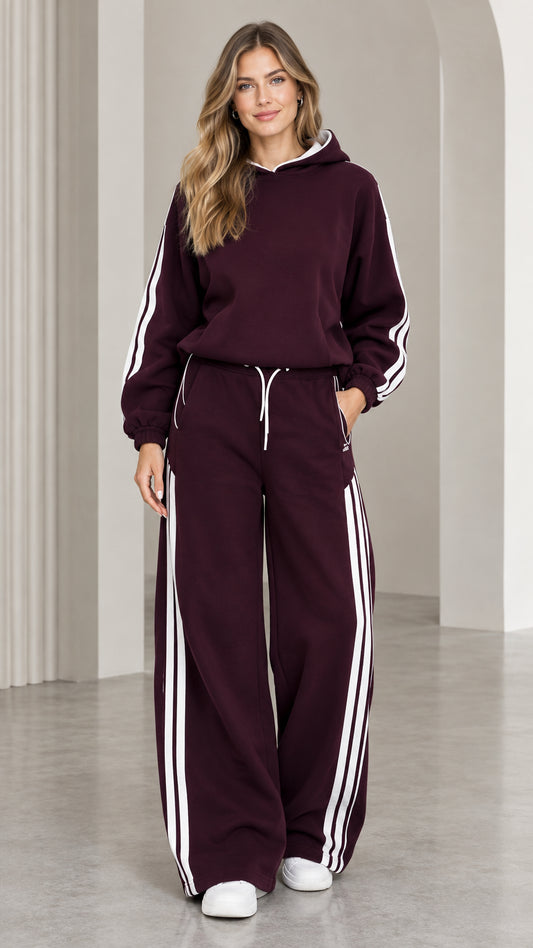 Front view of woman wearing burgundy two-piece hoodie and wide leg sweatpants tracksuit set