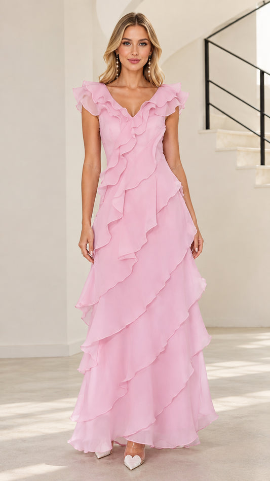 Front full-length view of woman in blush pink tiered ruffle V-neck maxi evening gown