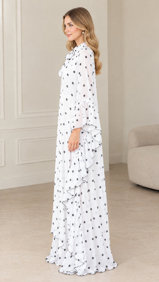 Side profile of flowing white polka dot maxi kaftan dress with ruffle details