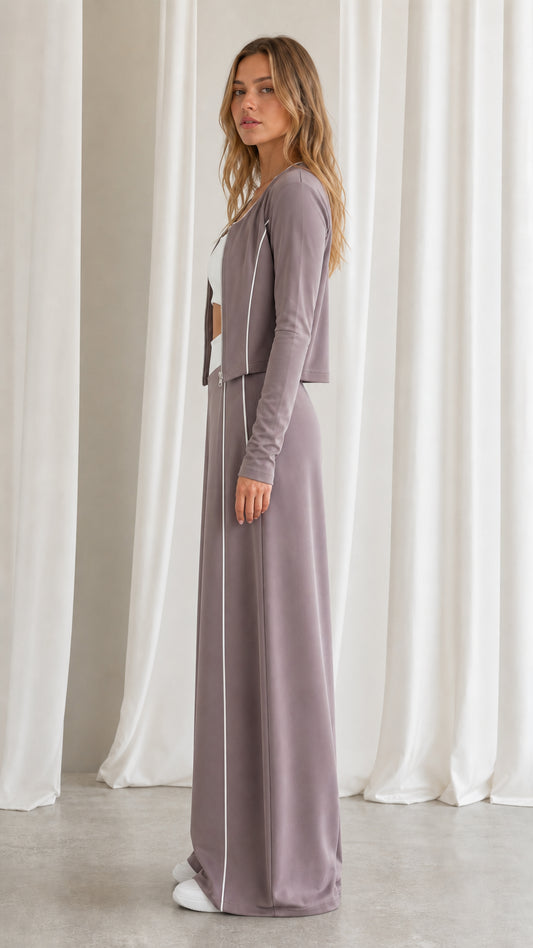 Side profile view of women's dusty mauve cropped zip jacket and wide-leg track pants set