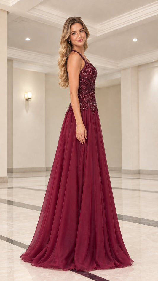 Side profile of model wearing floor-length burgundy formal dress with beaded bodice