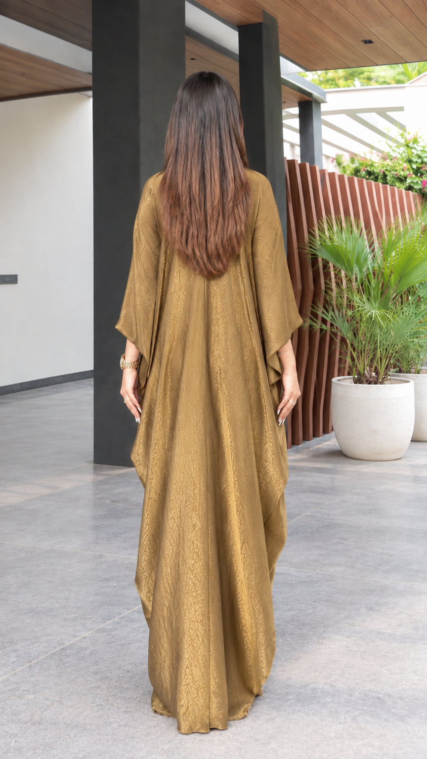 Back view of model showing the flowing drape of the gold maxi kaftan dress