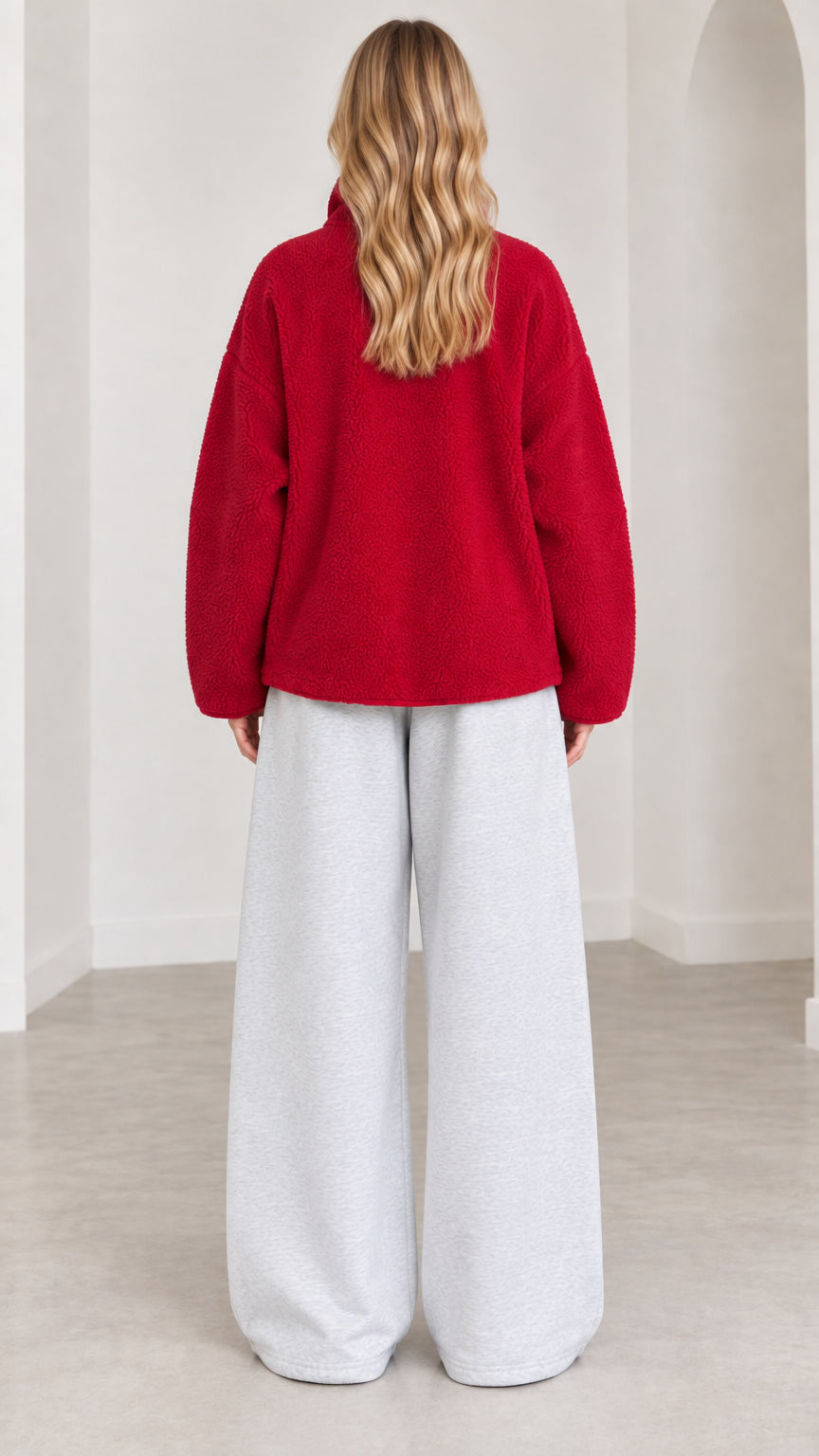 Back view of model in red cozy fleece zip jacket