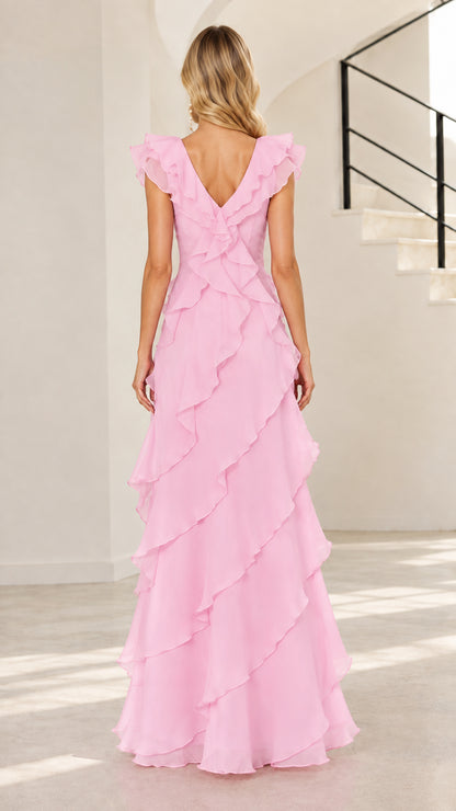 Back view of woman wearing blush pink V-neck tiered ruffle evening dress
