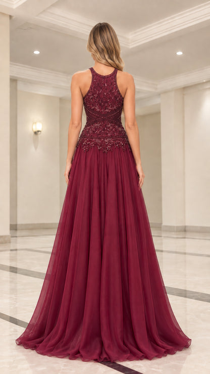 Back view of model in burgundy halter neck evening gown with flowy skirt