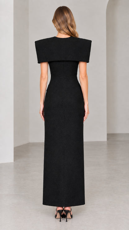 Back view of black tailored tweed maxi dress with structured shoulder cape