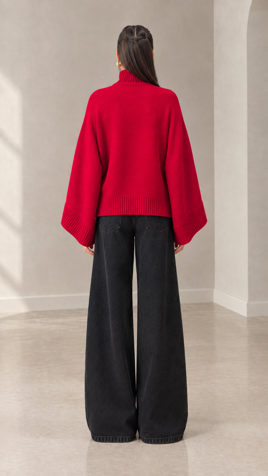 Back view of woman wearing red mock neck batwing knit cardigan