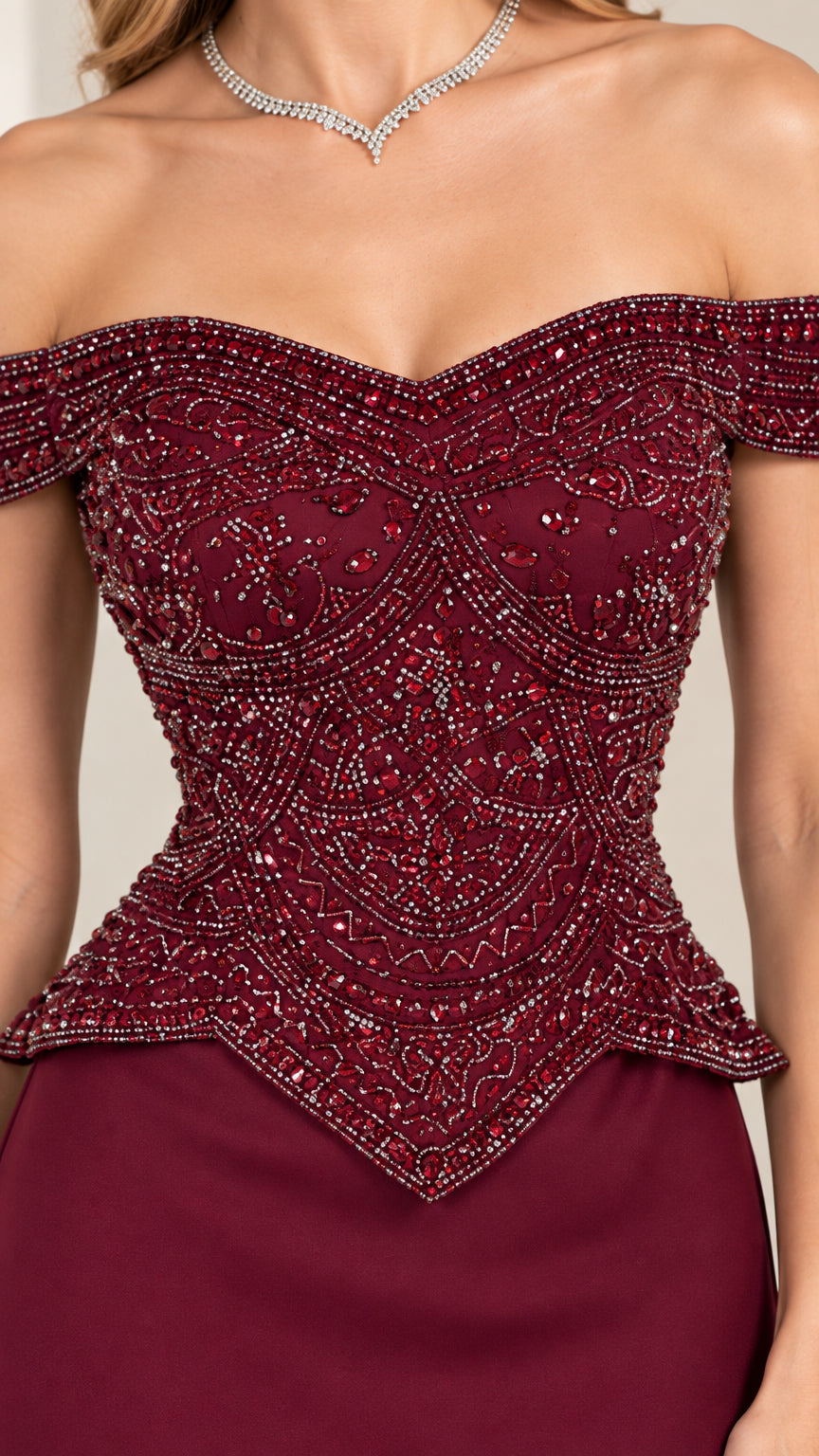 Close-up detail of burgundy intricately beaded bodice with basque waist