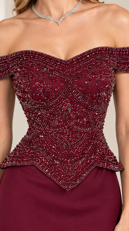 Close-up detail of burgundy intricately beaded bodice with basque waist