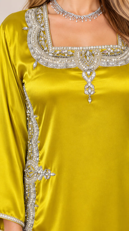 Close up view of intricate rhinestone and beadwork embellishments on square neckline