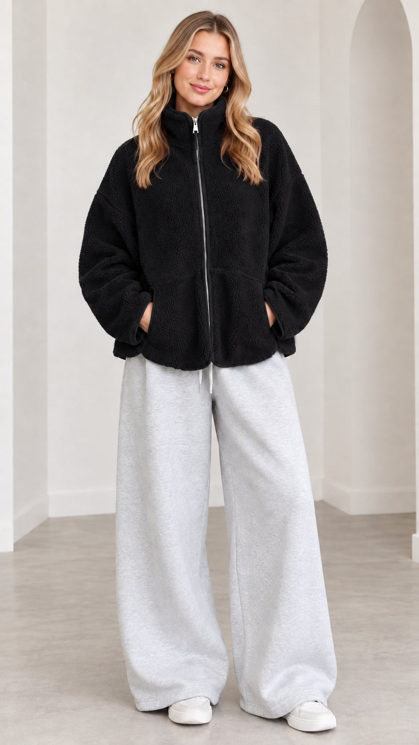 Model wearing black sherpa fleece zip jacket