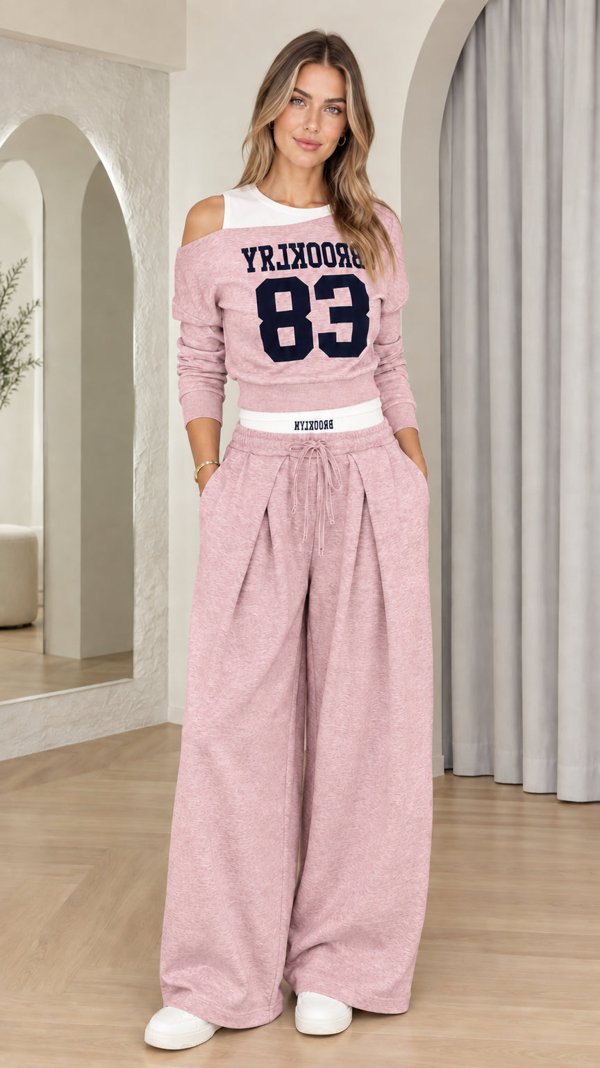 Front view of woman wearing Dusty Pink Brooklyn 83 cutout top and wide-leg pants set