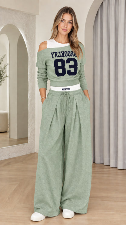 Front view of woman wearing Sage Green Brooklyn 83 cutout sweatshirt and matching pants set