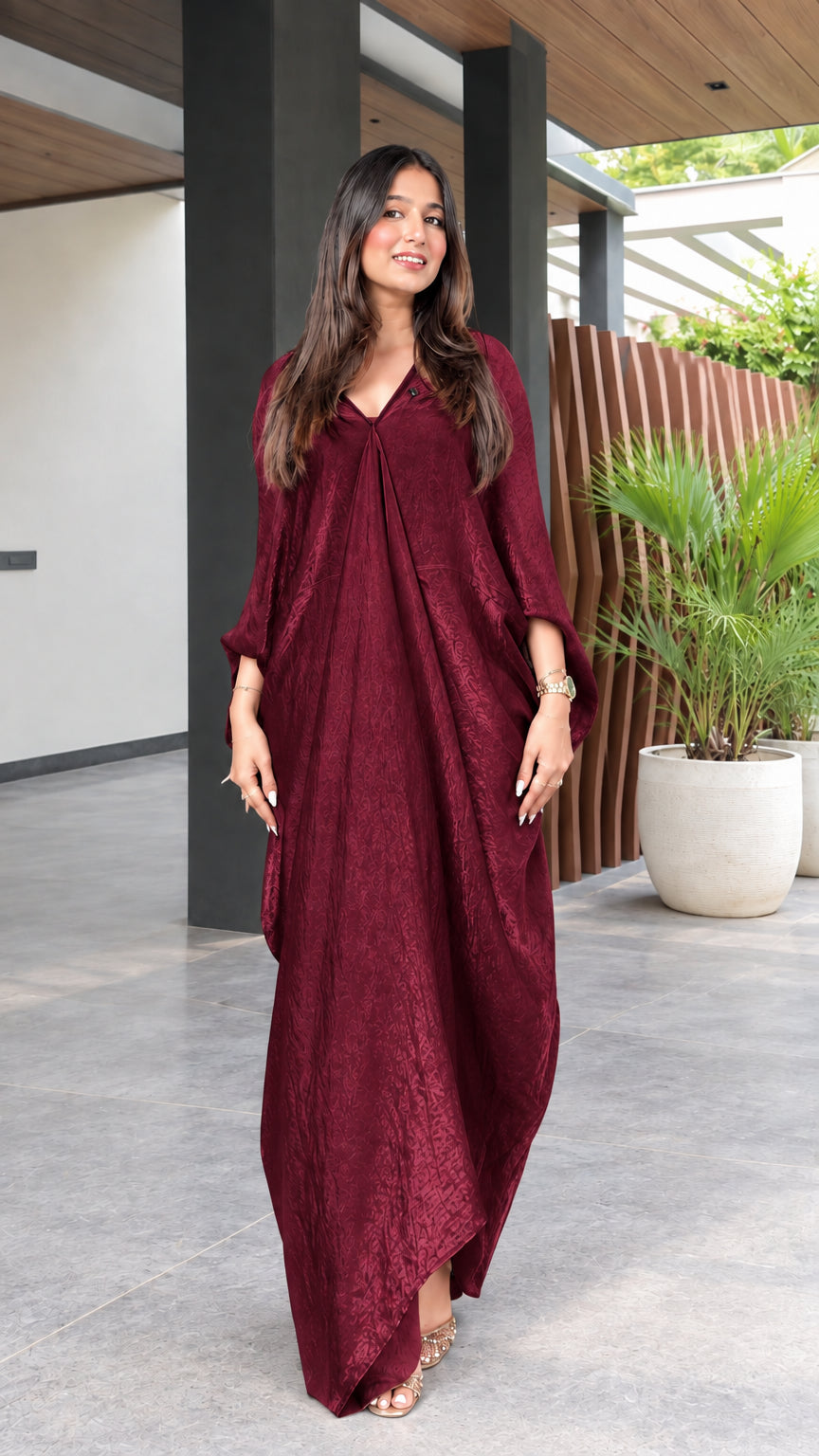 Front view of model wearing a deep burgundy wine textured maxi kaftan dress