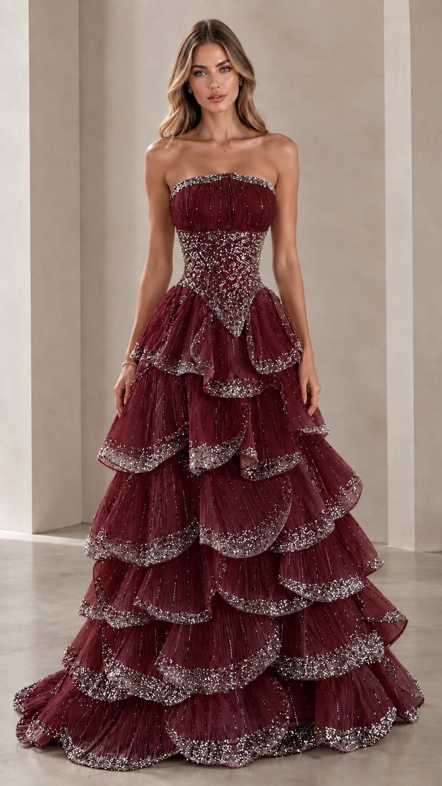 Model wearing Burgundy wine red strapless tiered formal dress