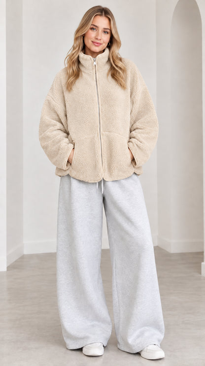 Model wearing beige sherpa fleece zip jacket