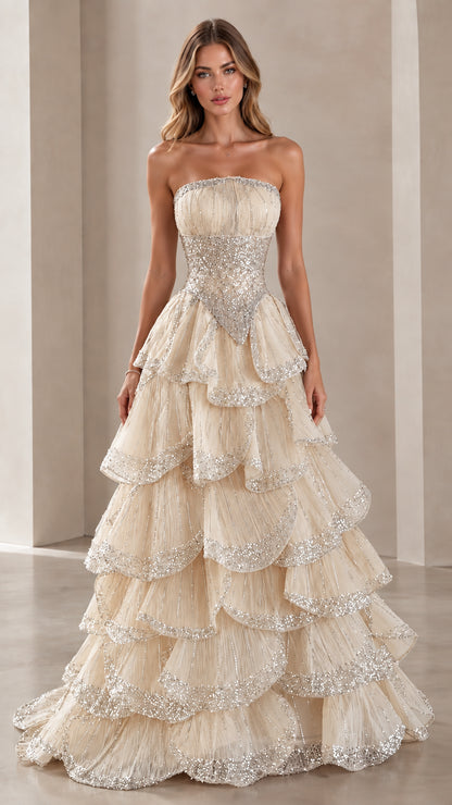 Model wearing Champagne gold strapless tiered sequin ball gown