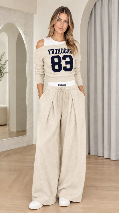 Front view of woman wearing Beige Brooklyn 83 matching lounge sweatshirt and wide-leg set